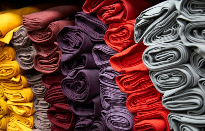 Bunch of beautiful fabrics stacked together.