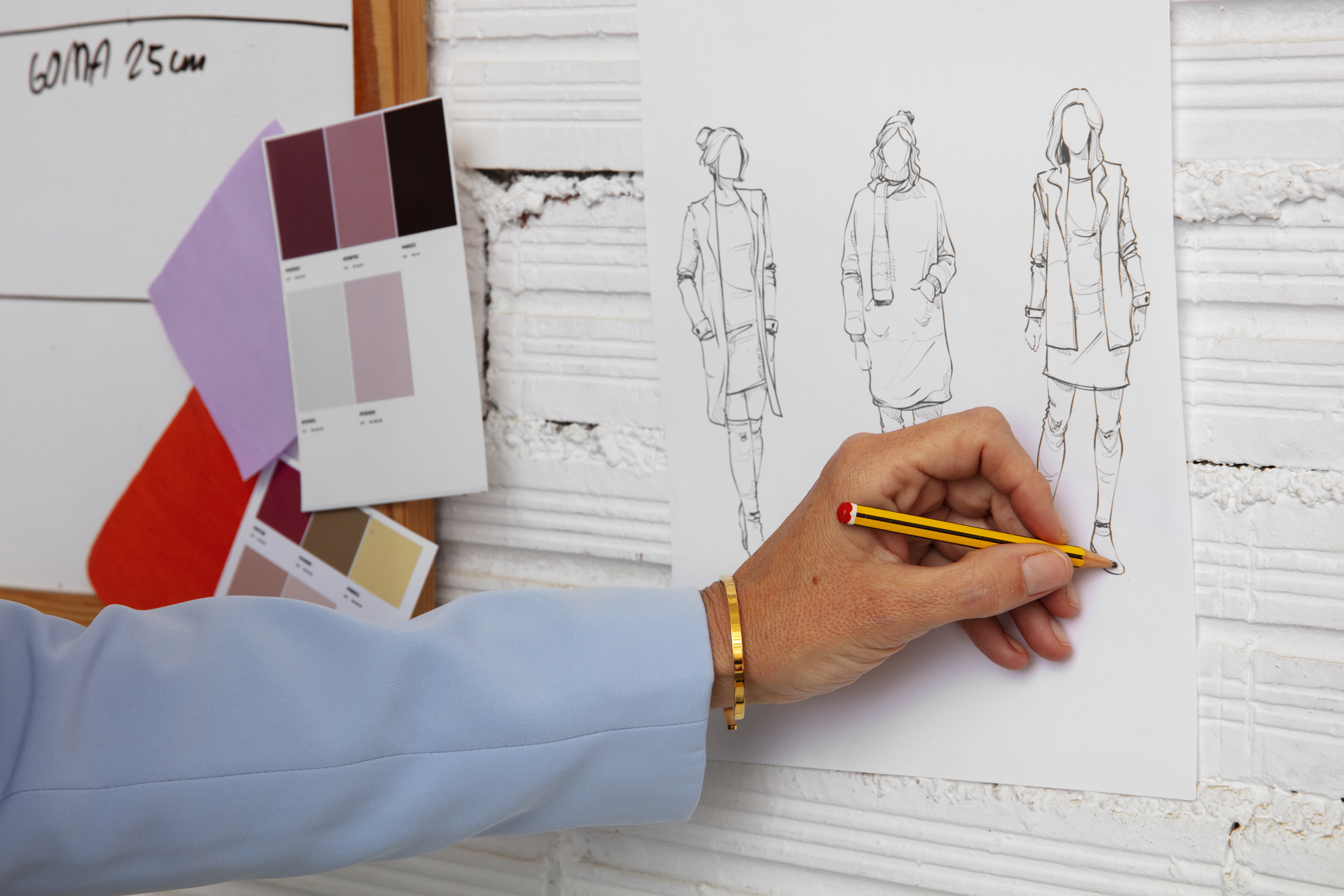 Fashion designer working on collection sketches